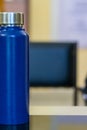 Blue Water Bottle with Steel Cap on Glass Table Royalty Free Stock Photo