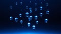 Blue water bubbles floating in dark deep water with light reflections Royalty Free Stock Photo