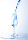 Blue water drinks splash pouring into wine glass Royalty Free Stock Photo