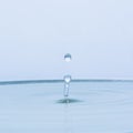 Blue water drop falling down Royalty Free Stock Photo