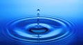 Blue water drop with ripples Royalty Free Stock Photo