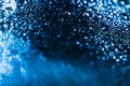 Blue water drops background. Water drops on a car glass background. Water drops on car glass blue bokeh background. Royalty Free Stock Photo