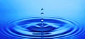 Blue water drops with ripples Royalty Free Stock Photo