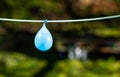 Blue, water-filled balloon on a line. Soon to burst Royalty Free Stock Photo