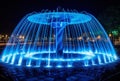 blue water fountain with LED lights at night view generative AI Royalty Free Stock Photo