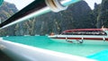 Blue water, green hills and steep rocks. The boat sails near the island. Boat with tourists in the Bay