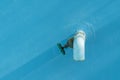 Blue water hose with water valve and blue background Royalty Free Stock Photo