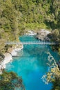 Blue water lake with suspension bridge in tropical jungle Royalty Free Stock Photo