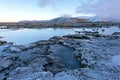 The blue water between the lava stones near Reykjavik in winter, Iceland