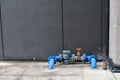 Blue water meter and valve supply pipe with joint on cement floor. Plumber installing water equipment. Royalty Free Stock Photo