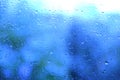 Blue water outside window out focus, texture glass of background with water drops, place for text, horizontal banner with blurry Royalty Free Stock Photo