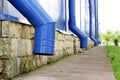 Blue water pipes on a large sports complex in summer. concept of protection against heavy downpours Royalty Free Stock Photo