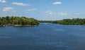 Blue water in the river. The forest is green. Sky is blue. White lush clouds. Summer landscape Royalty Free Stock Photo