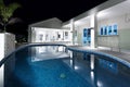 Blue water round swimming pool with a hotel Royalty Free Stock Photo