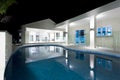 Blue water round swimming pool with a hotel Royalty Free Stock Photo