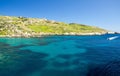 Blue water and sailing motor boat near town Mgarr, Gozo island Royalty Free Stock Photo