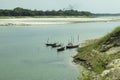 Blue water and some boat floating on the water and surrounded by green Royalty Free Stock Photo