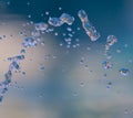 Blue water splashing in front of blue and white background Royalty Free Stock Photo