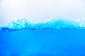 Blue water surface with air bubbles and splashes. Abstract background. Royalty Free Stock Photo