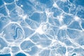 Blue water surface with bright sun light reflections, water in swimming pool background Royalty Free Stock Photo