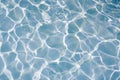 Blue water surface with bright sun light reflections, water in swimming pool background Royalty Free Stock Photo