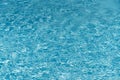 Blue water in swimming pool background. Ripple Water in swimming pool with sun reflection. Blue swimming pool rippled Royalty Free Stock Photo