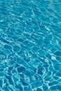 Blue water in swimming pool background. Ripple Water in swimming pool with sun reflection. Blue swimming pool rippled water detail Royalty Free Stock Photo