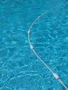 Blue water of a swimming pool with a rope floating