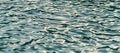 Blue water texture, with ripples and sun reflections Royalty Free Stock Photo