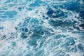 Blue water waves and white spindrift in the sea Royalty Free Stock Photo