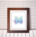 Blue watercolor butterfly in black frame on white brick wall Royalty Free Stock Photo