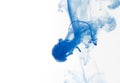 Blue watercolor paint drops in water with white background Royalty Free Stock Photo