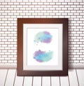 Blue watercolor stains in a black frame on a white brick wall Royalty Free Stock Photo