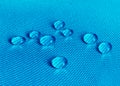 Blue waterproof fabric with waterdrops close up Royalty Free Stock Photo