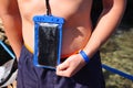 Blue waterproof smartphone case for taking pictures underwater Royalty Free Stock Photo