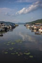 The blue waters of Otsego Lake in Cooperstown, New York, on a sunny summer day with cumulus clouds in the sky, photographed near a Royalty Free Stock Photo