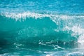 Blue wave in tropical ocean. Barrel crashing and sun light. Clear water.