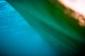 Blue wave underwater in ocean and sunset colors. Clear barrel wave Royalty Free Stock Photo