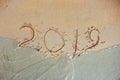 Blue Wave Washing Away 2019 Year Handwritten On Sandy Beach inscription