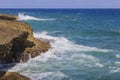 Blue waves from Caribbean Sea crash against rocky shores of Aruba Island Royalty Free Stock Photo
