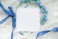 Blue wedding invitation square mockup decorated with silk ribbon, crystals and bride wreath