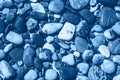 Blue wet pebble stones and water at morning seaside Royalty Free Stock Photo