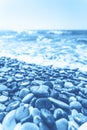 Blue wet pebble stones and water at morning seaside Royalty Free Stock Photo