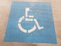 Blue wheelchair or handicapped parking symbol on cement Royalty Free Stock Photo