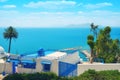 Blue and white Arabic cafe against the sea in Sidi Bou Said. Seascape, mountains and palm trees in Tunisia. June, 2019 Royalty Free Stock Photo