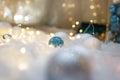 Blue and white baubles. Christmas tree toys and New Year decorations. Unfocused white background with shiny sparkling garland Royalty Free Stock Photo