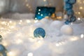 Blue and white baubles. Christmas tree toys and New Year decorations. Unfocused white background with shiny sparkling garland Royalty Free Stock Photo