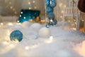 Blue and white baubles. Christmas tree toys and New Year decorations. Unfocused white background with shiny sparkling garland Royalty Free Stock Photo