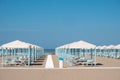 Blue and white beach cabanas lined up and ready for beachgoers in Viareggio, Italy Royalty Free Stock Photo
