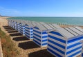 Blue and white beach huts on the pebbled beach at Hastings